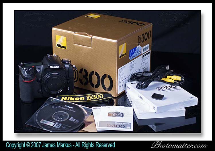 Photo of Nikon D300 box has camera body, software CD, neck strap, battery, charger, Nikon D300 manual, cables and quick guide